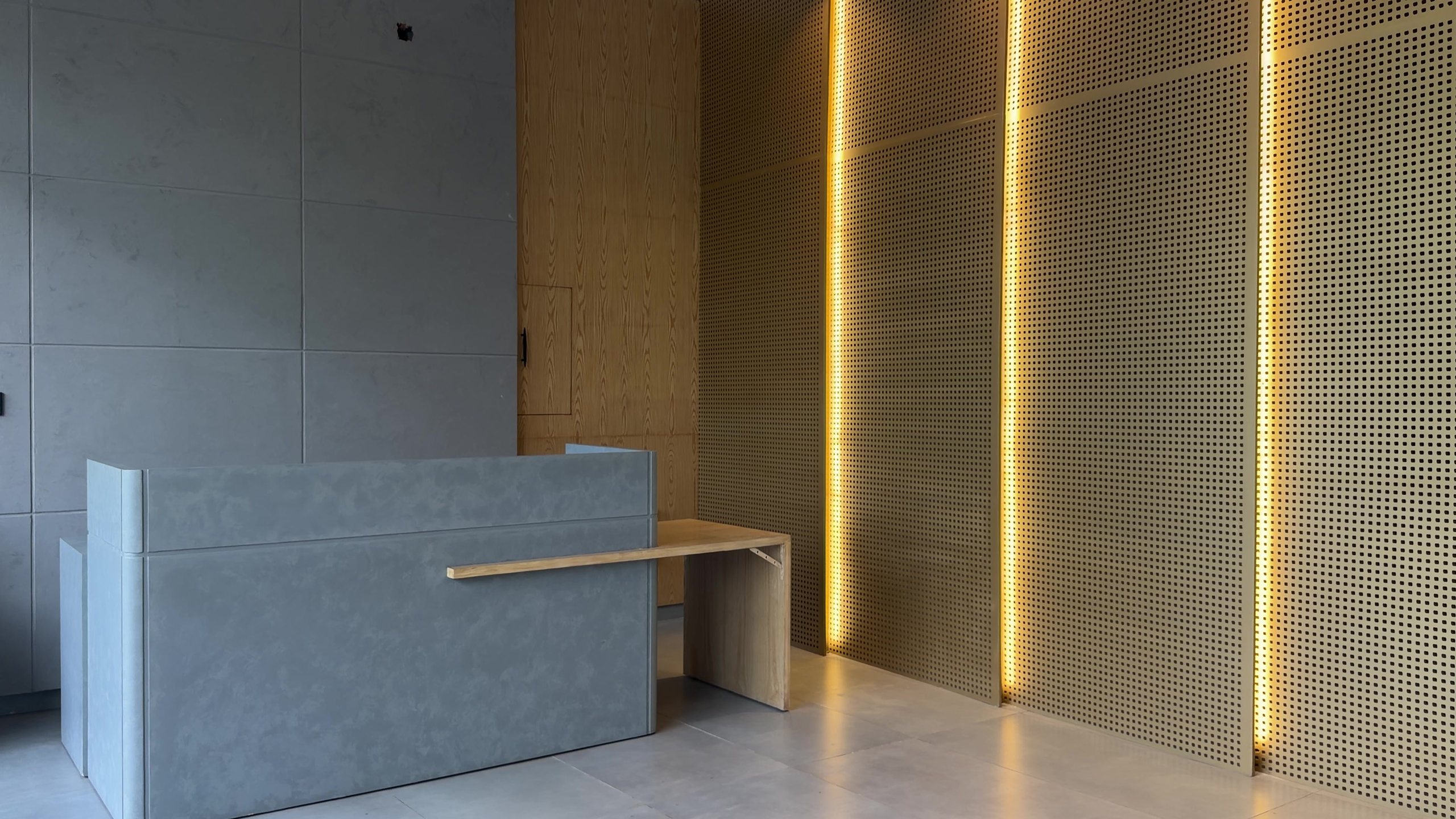 OneDesk reception desk with lit wooden panels